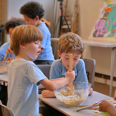 boy cooking at Just Kidding after school club